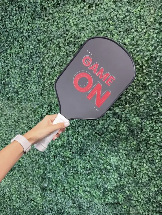 Custom charcoal pickleball paddle with bold Game On type