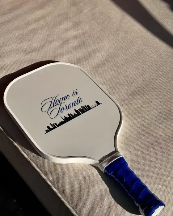 Custom white pickleball paddle with Home is Toronto script and skyline