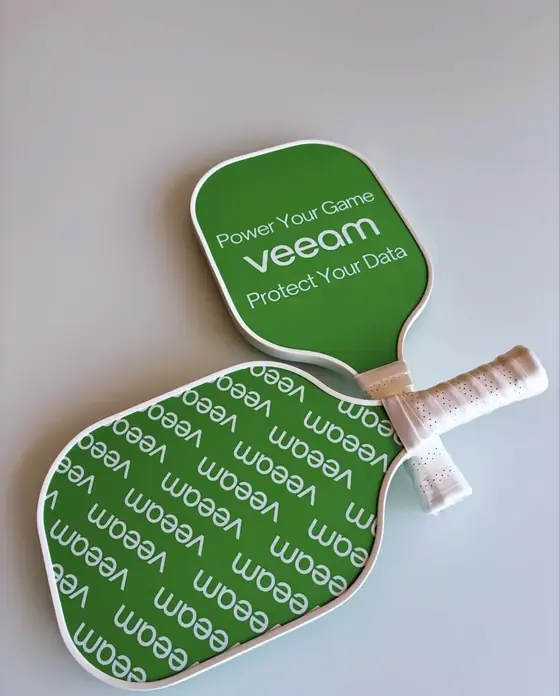 Green Veeam branded pickleball paddle showing logo front and all-over pattern back