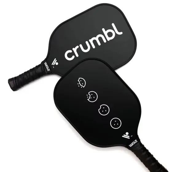 Two black Crumbl branded pickleball paddles showing logo front and icon back