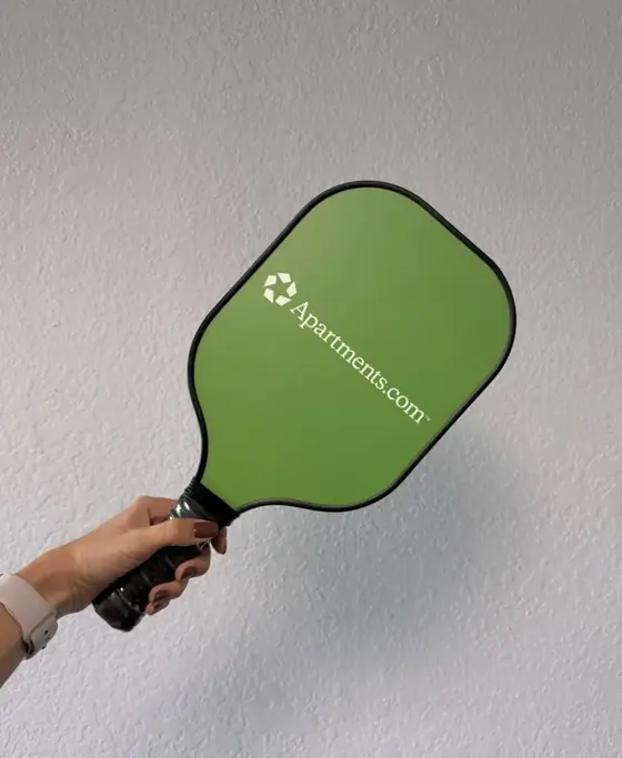 Custom green pickleball paddle printed with a corporate logo