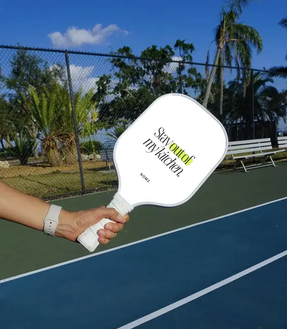 Custom white pickleball paddle with a funny kitchen slogan
