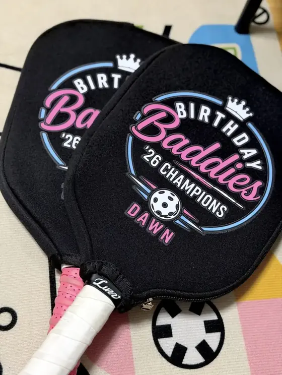 Two black neoprene paddle covers printed with a team logo